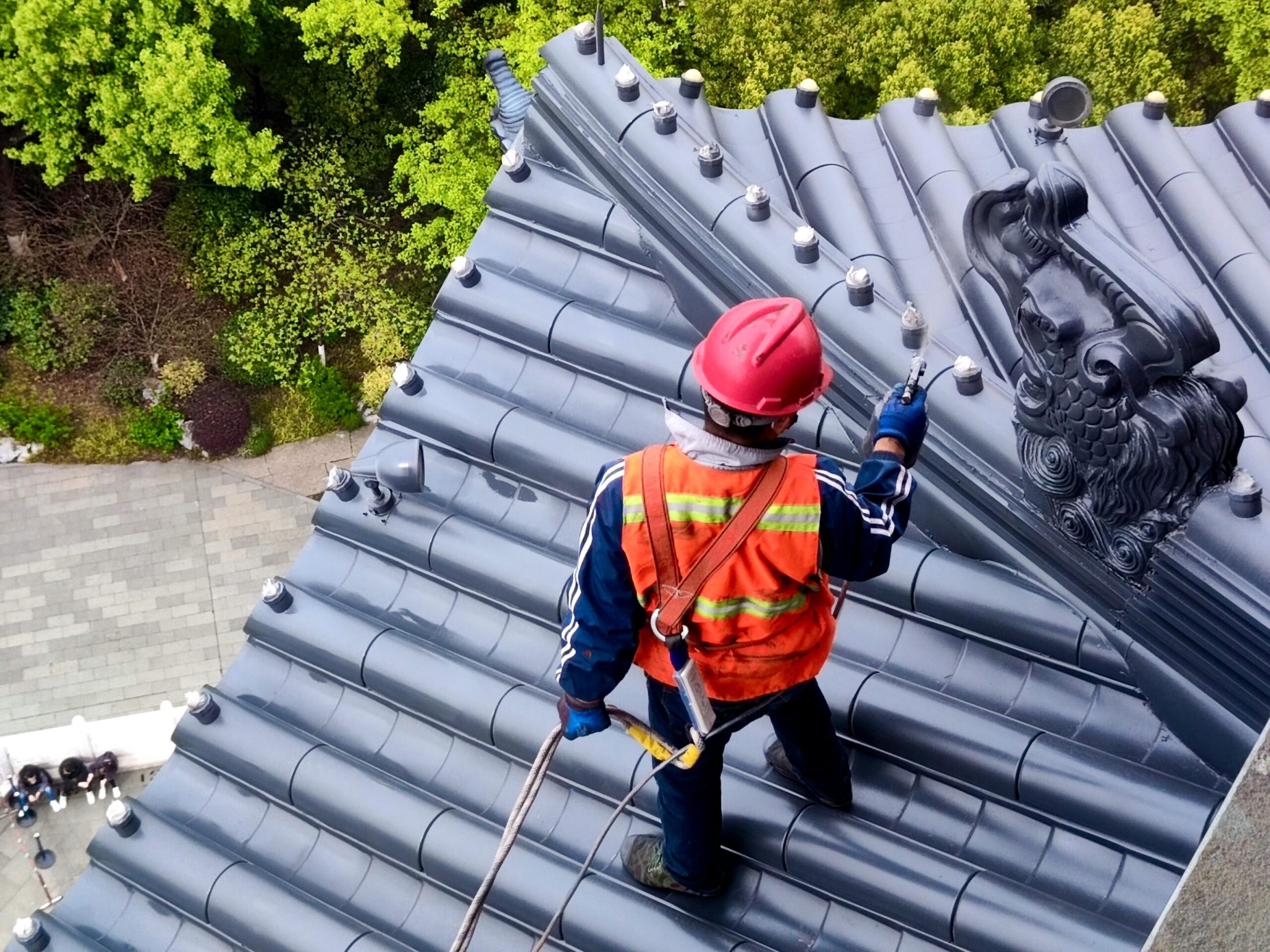 Professional roof cleaning in progress by Max's Real Estate Cleaning team in Los Angeles, CA, ensuring clean and debris-free roofs.