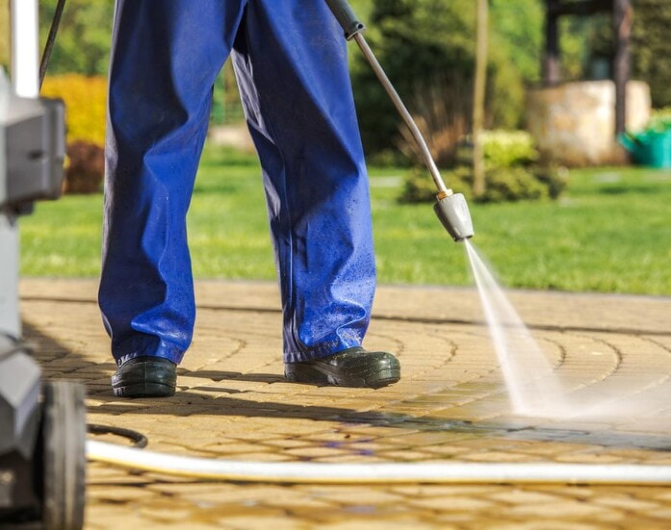 Professional pressure washing by Max's Real Estate Cleaning in Los Angeles, CA, cleaning a residential driveway.